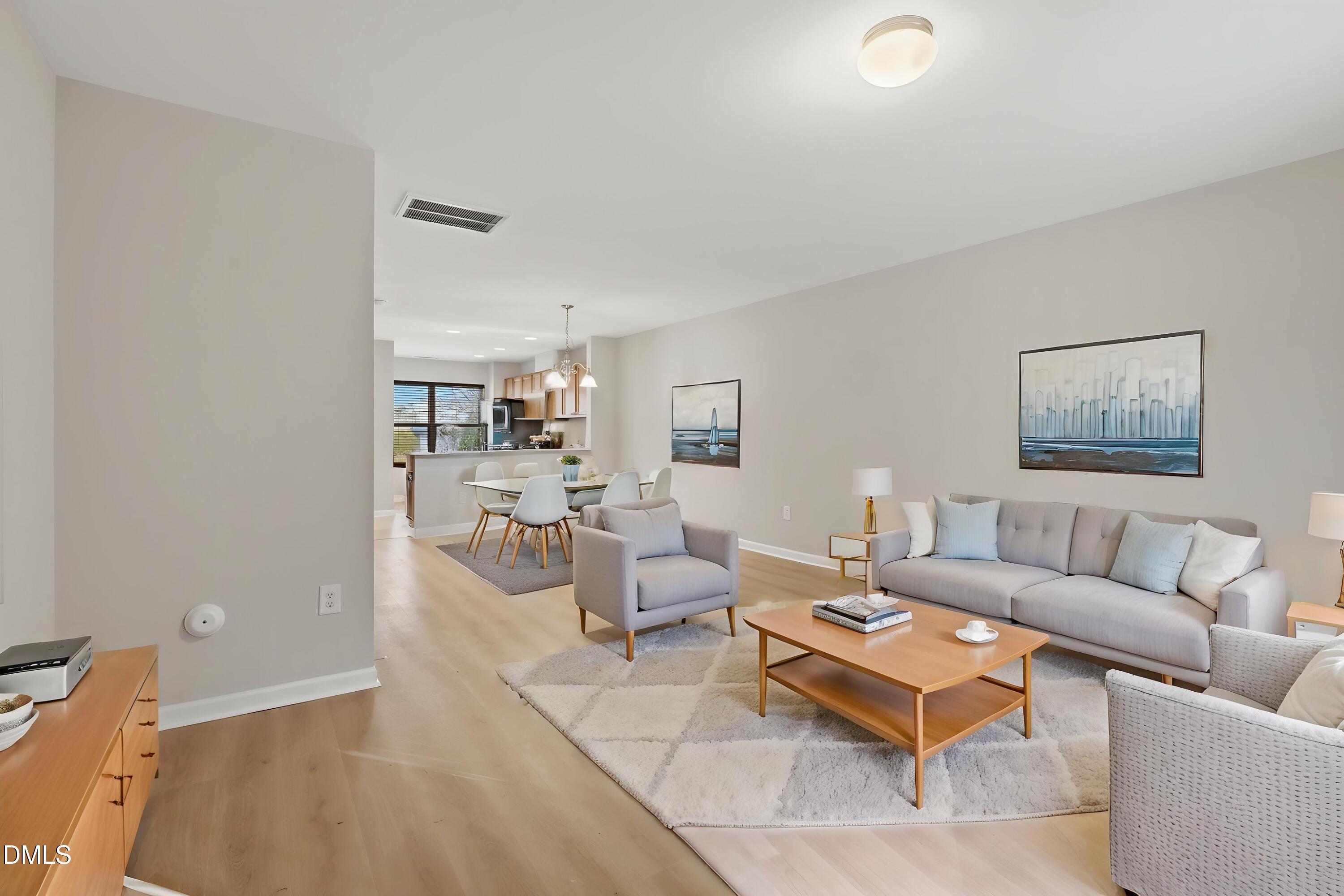 2907 Berkeley Springs Place Raleigh, NC 27616 - Photo 5 of 32 a living room with furniture and a wooden floor