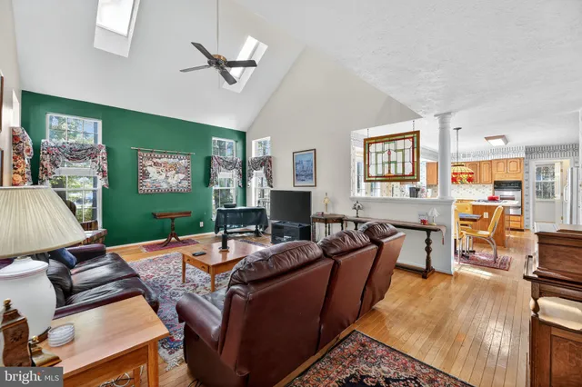 a living room with furniture a flat screen tv and a table