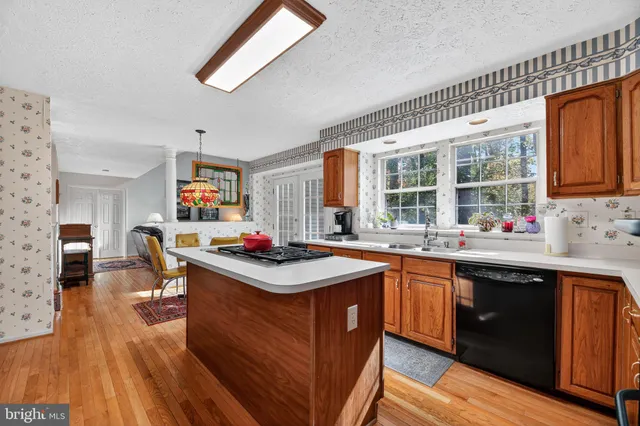 a kitchen with granite countertop a sink stove and cabinets
