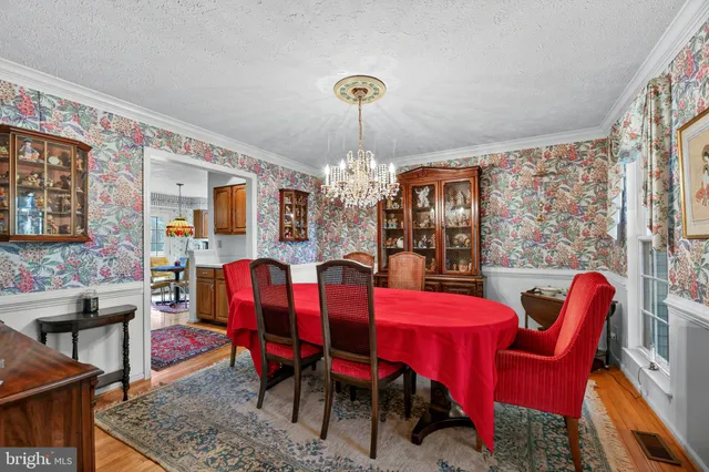 a view of a dining room with furniture and chandelier