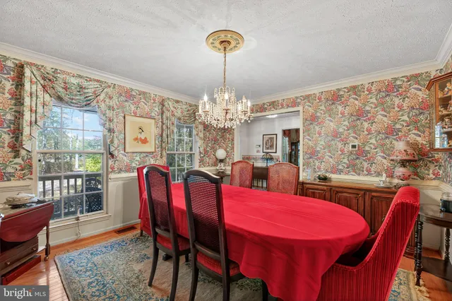 a view of a dining room with furniture and chandelier
