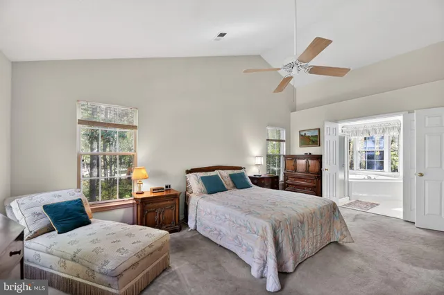 a bedroom with bed and wooden floor