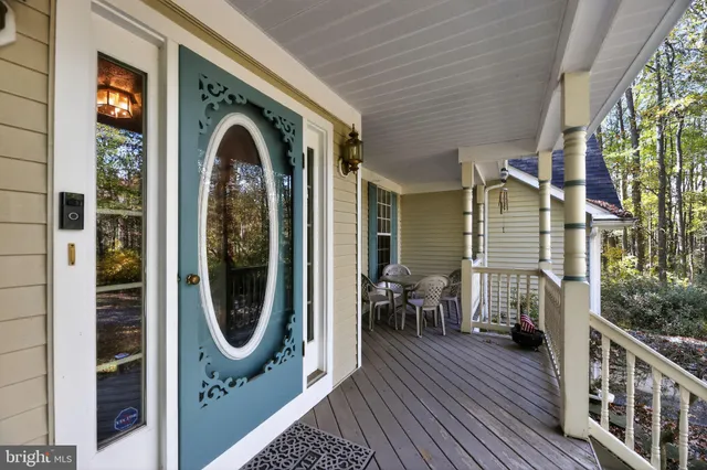 a view of a hallway with wooden floor and fence