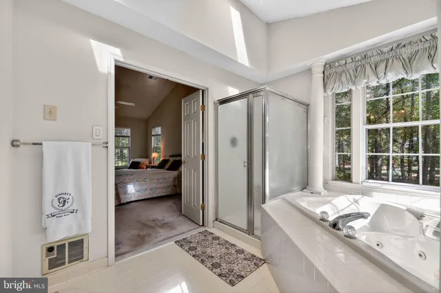 a living room with a bed and a large window