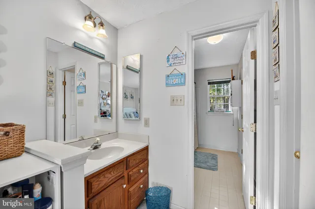 a bathroom with a sink a mirror and a shower