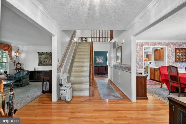 a view of entryway and hall with wooden floor