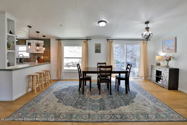 a view of a dining room with furniture window and wooden floor