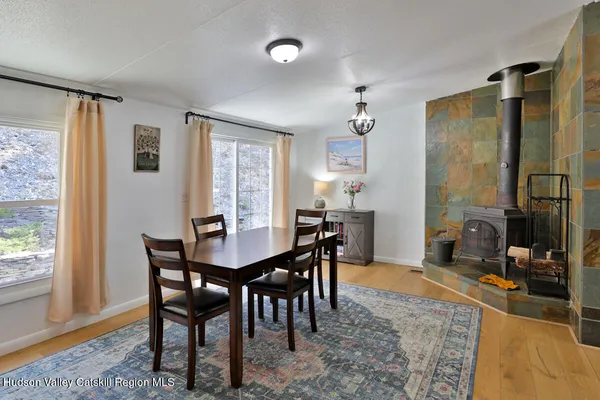 a view of a dining room with furniture window and wooden floor