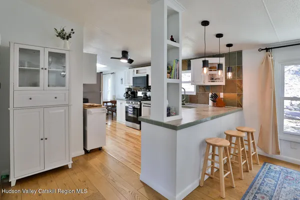 a kitchen with stainless steel appliances kitchen island granite countertop a table and chairs in it