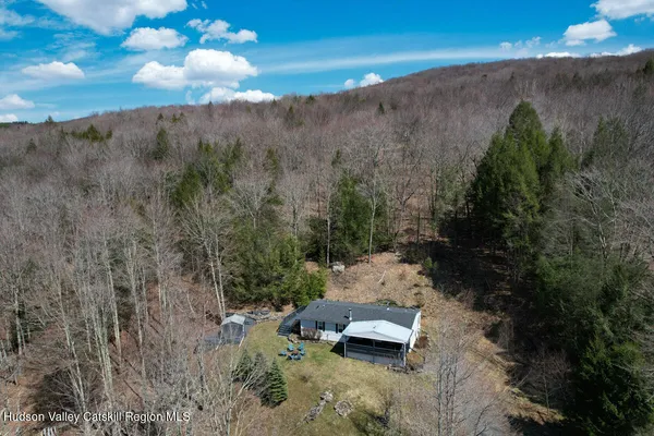 a view of a mountain with a yard