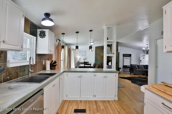 a kitchen with granite countertop a sink stove and cabinets