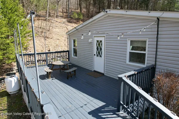 a view of a roof deck with wooden floor and fence