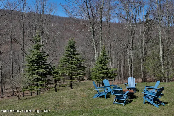 a view of a chair and tables in the back yard of the house