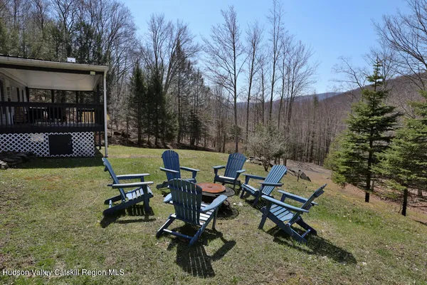 a view of a backyard with a tub and trees