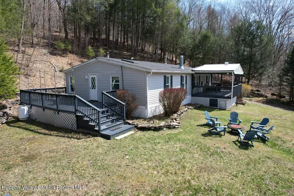 a view of a house with backyard and sitting area