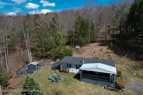 an aerial view of a house with a yard
