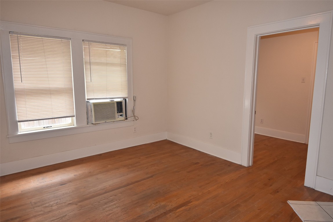 4618 Clay Street Houston, TX 77023 - Photo 11 of 20 a view of an empty room with wooden floor and a window