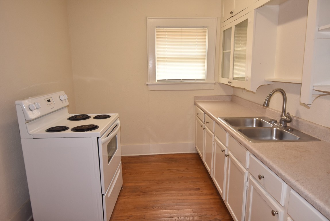 4618 Clay Street Houston, TX 77023 - Photo 14 of 20 a kitchen with sink a washer and dryer