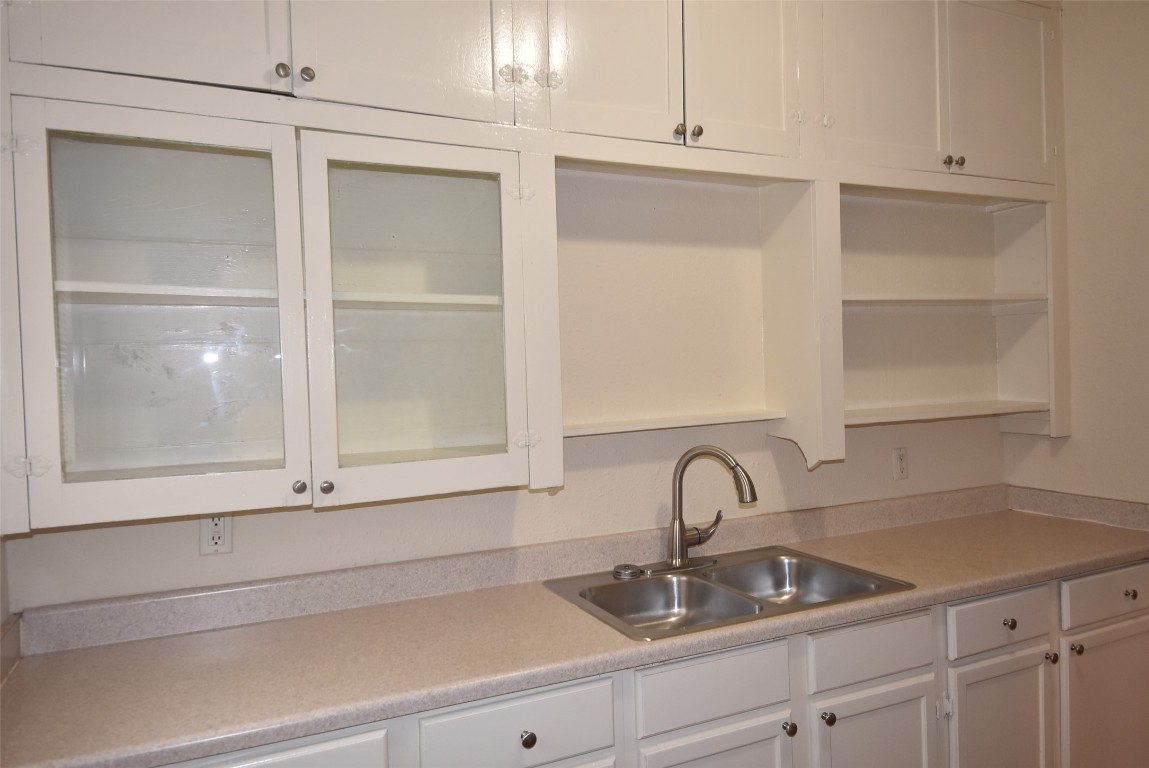4618 Clay Street Houston, TX 77023 - Photo 15 of 20 a close view of a sink and dishwasher with white cabinets