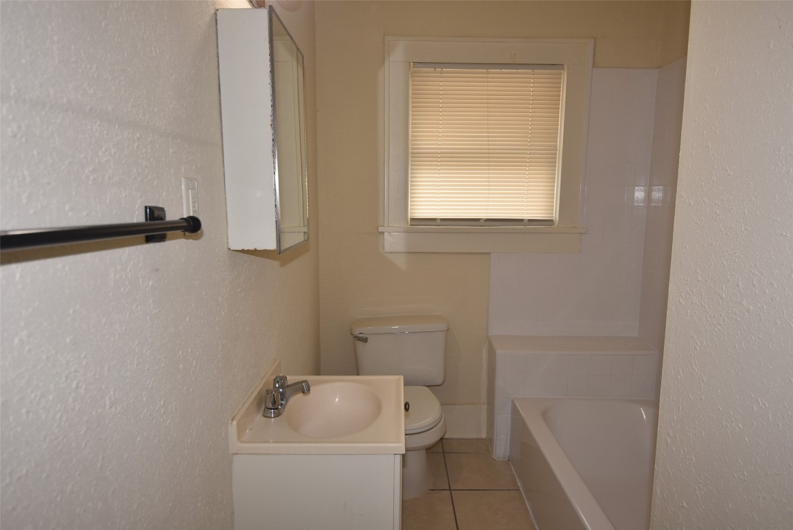 4618 Clay Street Houston, TX 77023 - Photo 16 of 20 a bathroom with a sink toilet and shower