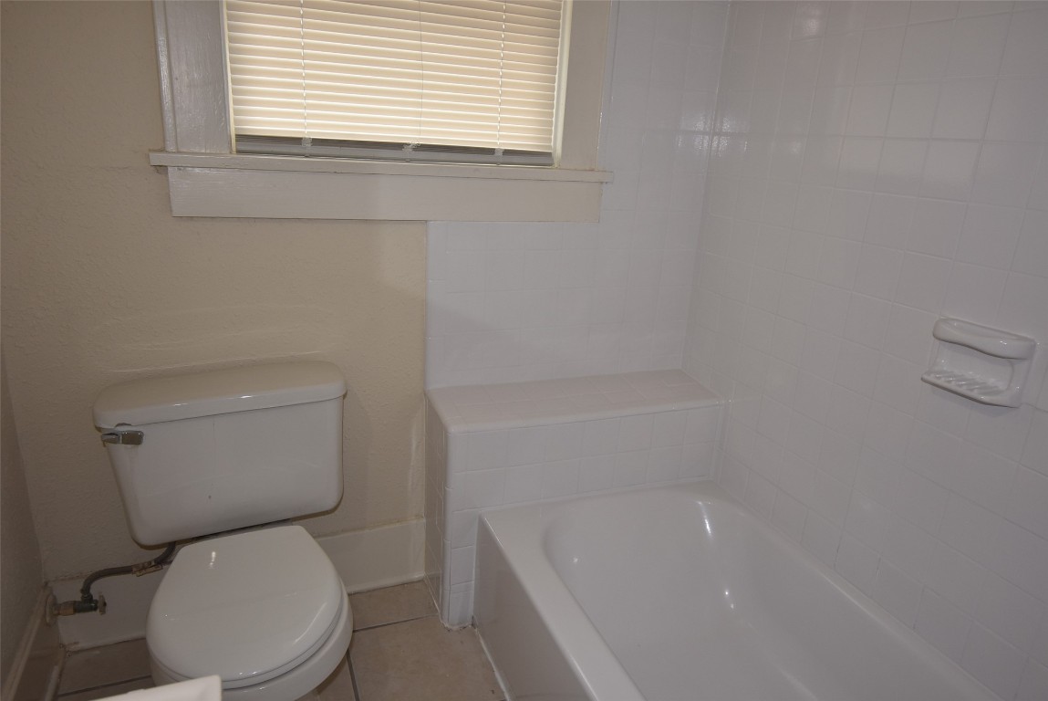 4618 Clay Street Houston, TX 77023 - Photo 18 of 20 a white toilet sitting next to a bath tub