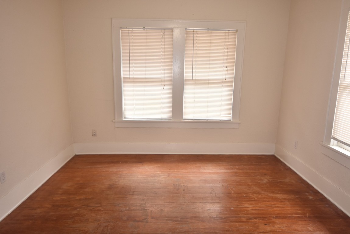 4618 Clay Street Houston, TX 77023 - Photo 19 of 20 an empty room with wooden floor and windows