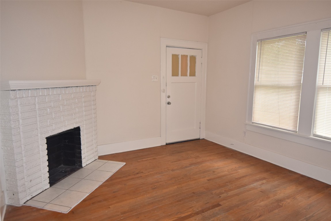 4618 Clay Street Houston, TX 77023 - Photo 9 of 20 an empty room with windows and fireplace