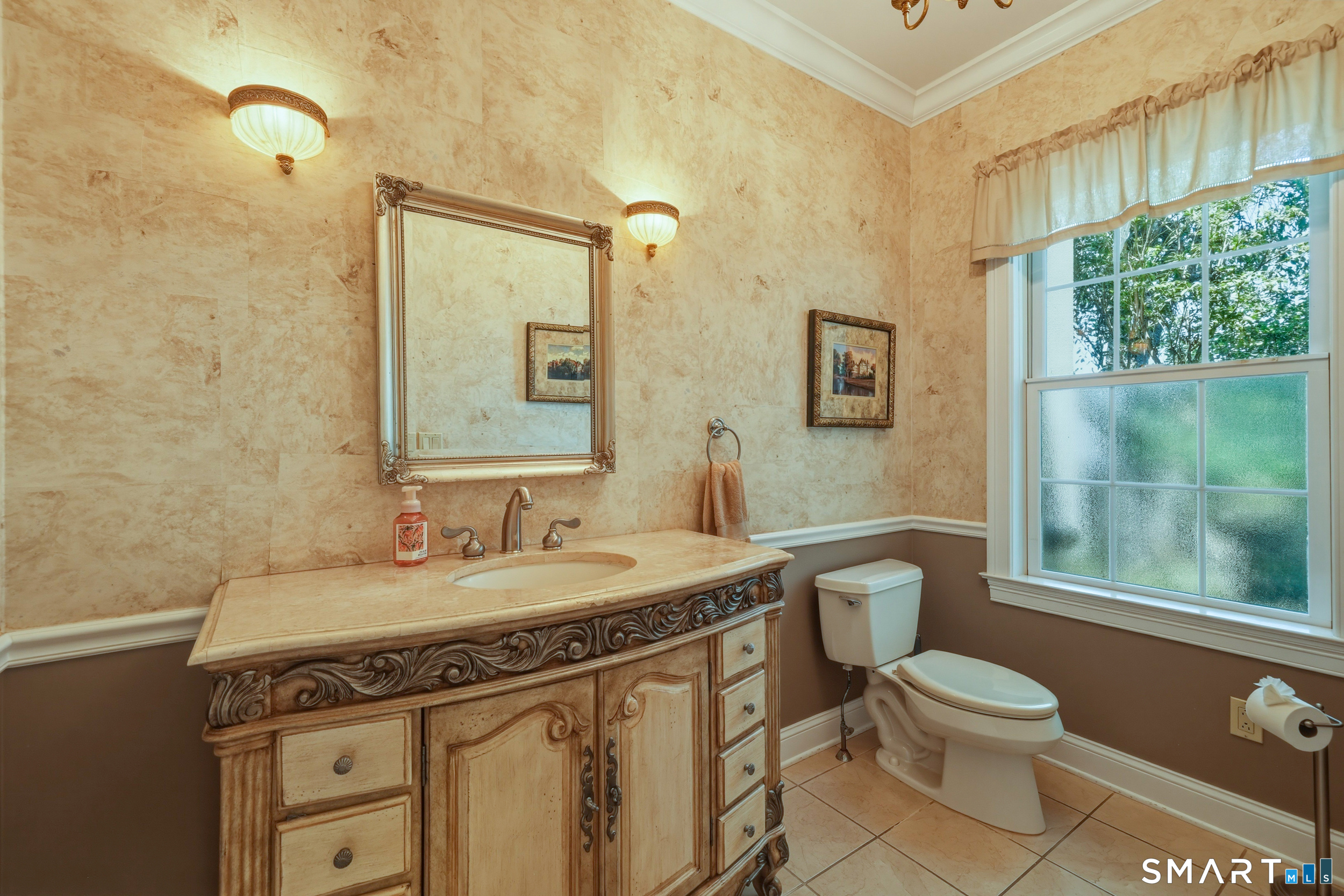 122 Lower Road Guilford, CT 06437 - Photo 21 of 40 A conveniently located main-level powder room with tile flooring and crown molding.