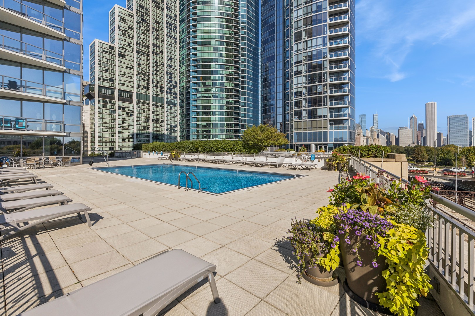 1235 South Prairie Avenue, Unit 2506 Chicago, IL 60605 - Photo 25 of 32 a building with swimming pool and lawn chairs