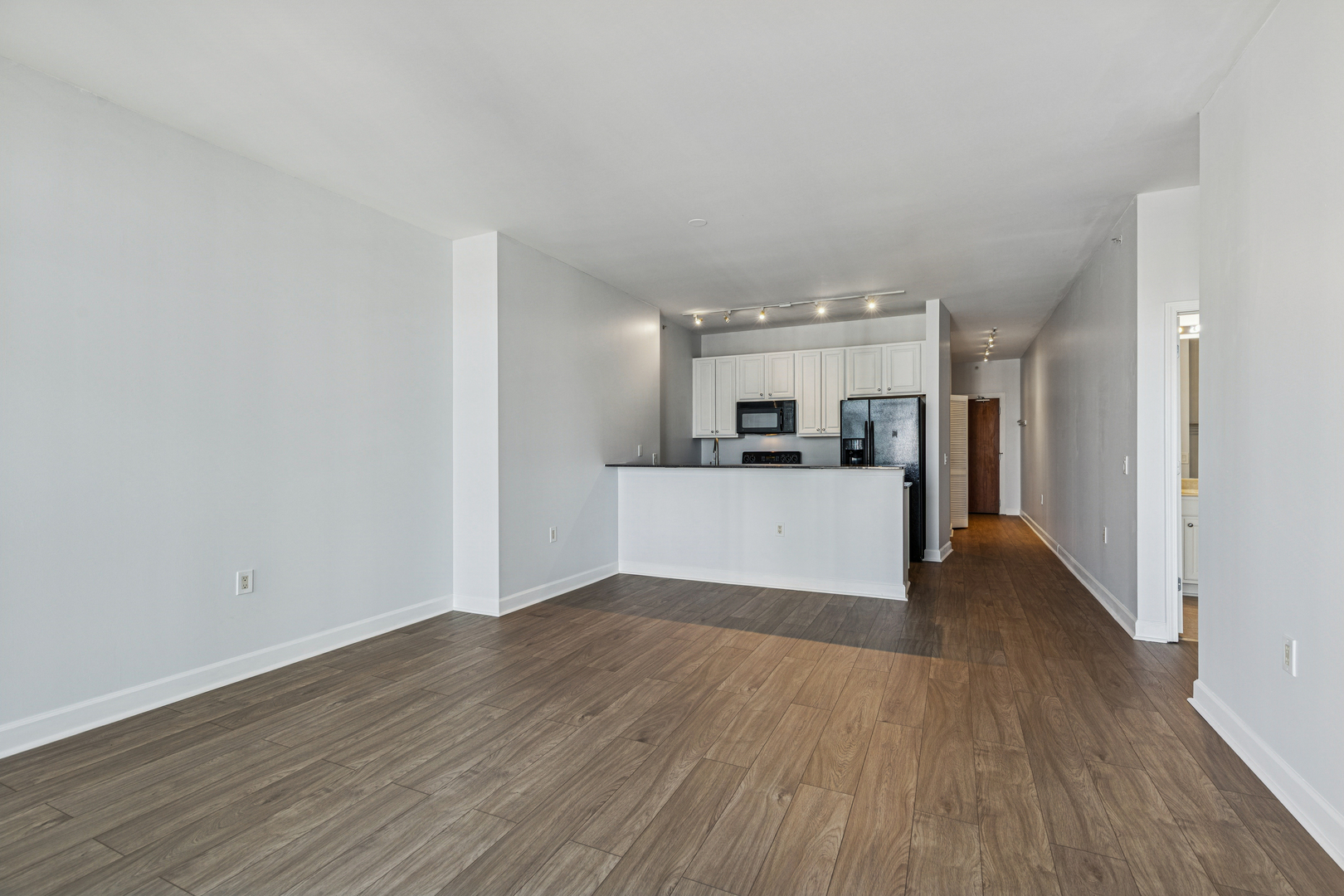 1235 South Prairie Avenue, Unit 2506 Chicago, IL 60605 - Photo 5 of 32 a view of a kitchen with wooden floor and a kitchen