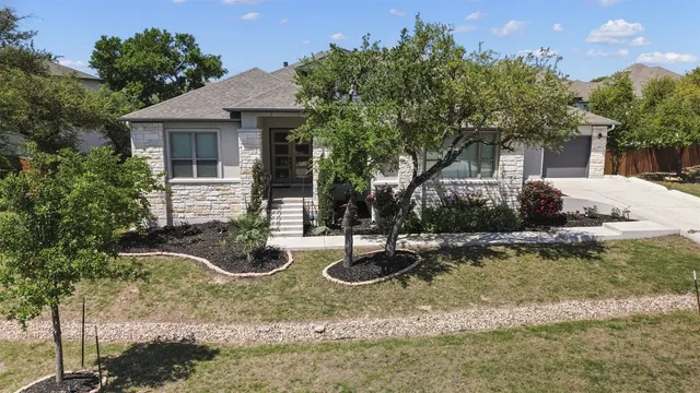 a view of a house with backyard and sitting area
