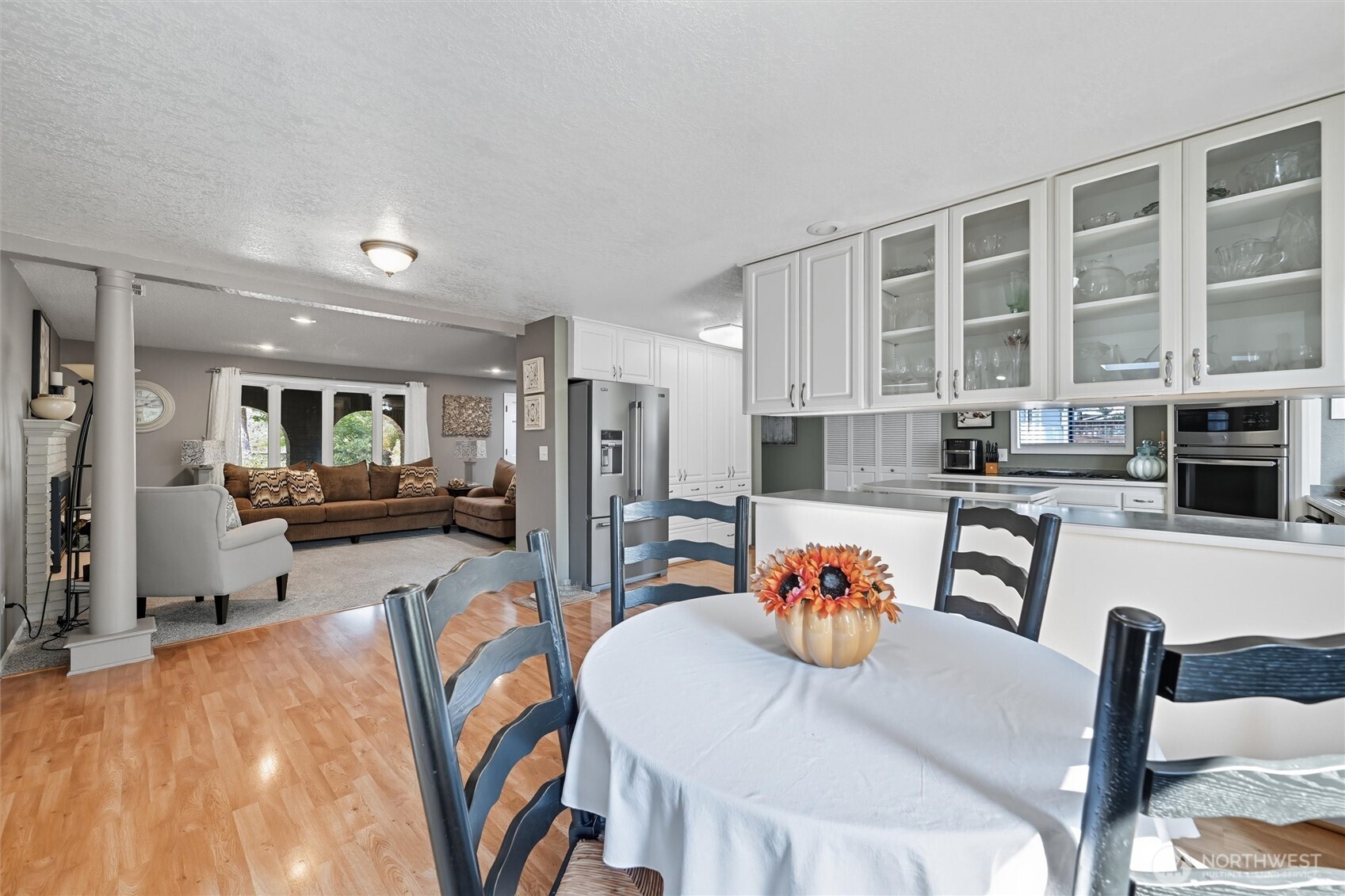 1125 Lattimore Road Ferndale, WA 98248 - Photo 12 of 39 a kitchen with stainless steel appliances granite countertop a stove a sink a dining table and chairs