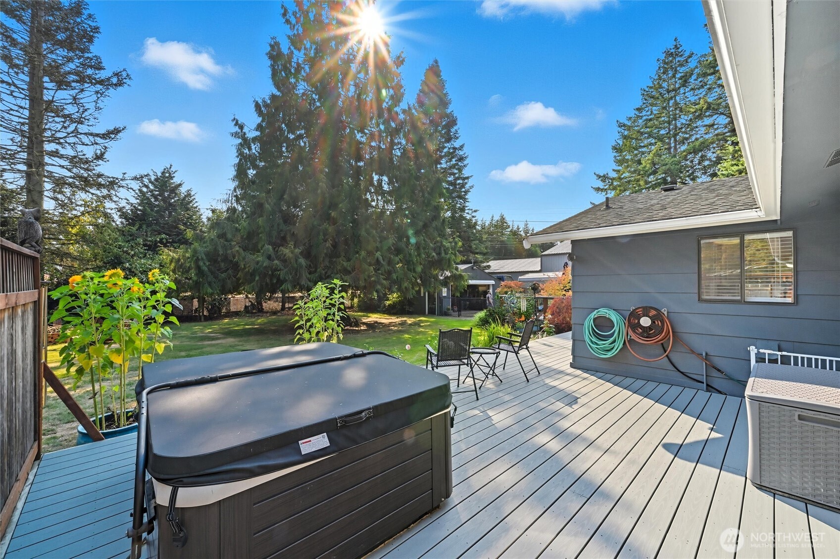 1125 Lattimore Road Ferndale, WA 98248 - Photo 26 of 39 a view of a patio with table and chairs with wooden floor and fence