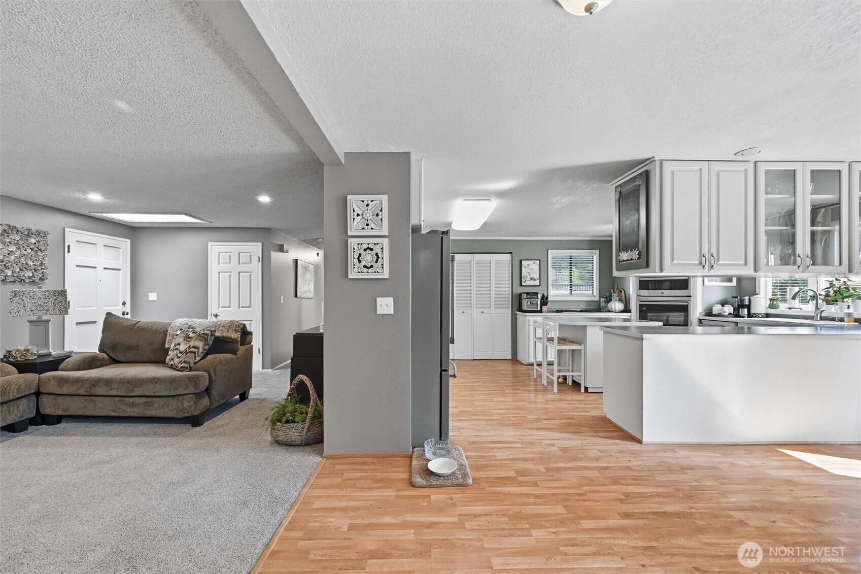 1125 Lattimore Road Ferndale, WA 98248 - Photo 7 of 39 a living room with furniture and a dining table with kitchen view