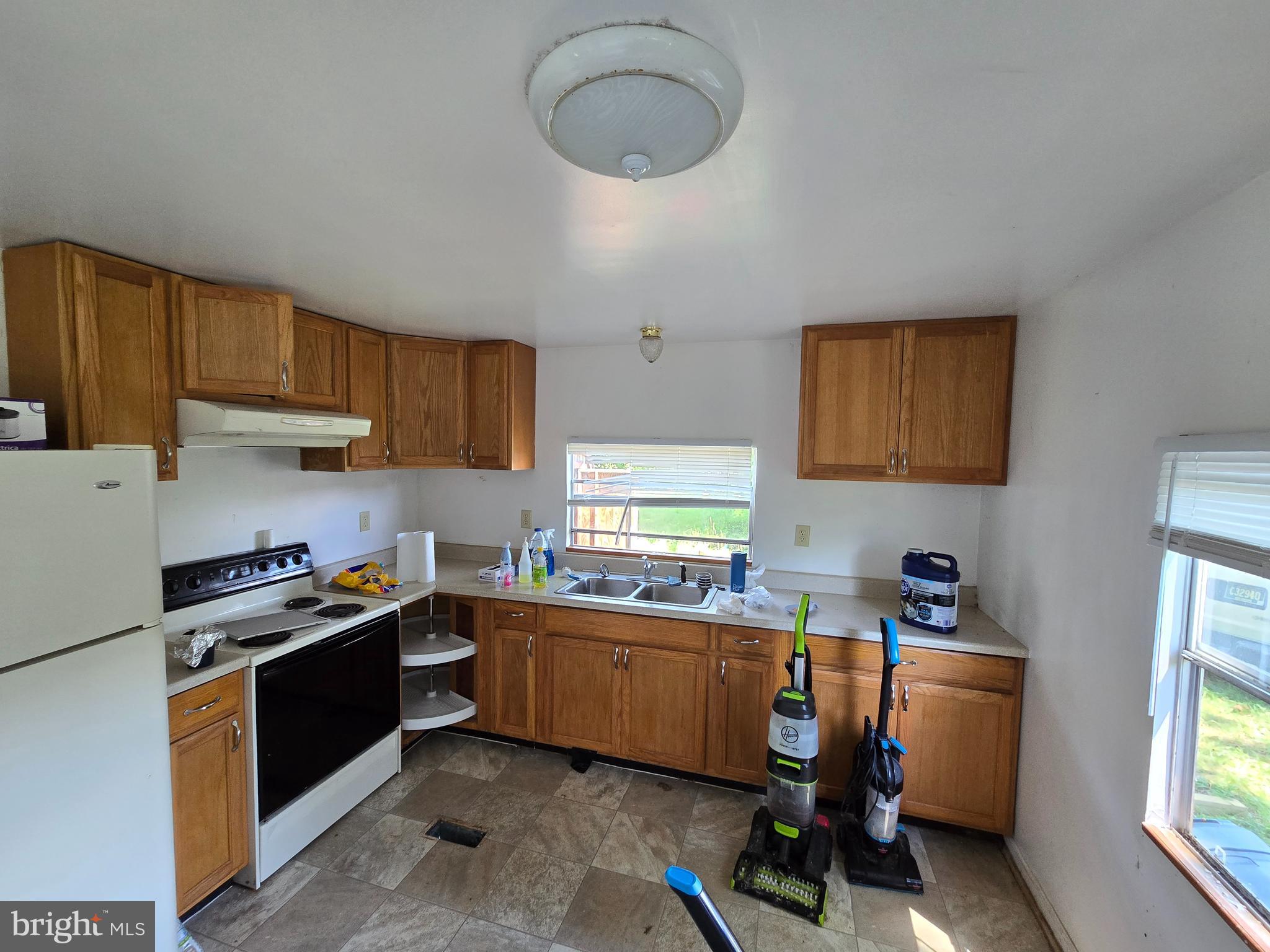 36676 Bi State Boulevard Delmar, DE 19940 - Photo 16 of 32 a kitchen with a sink a stove cabinets and a window
