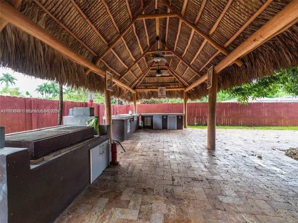 a view of a backyard with wooden fence