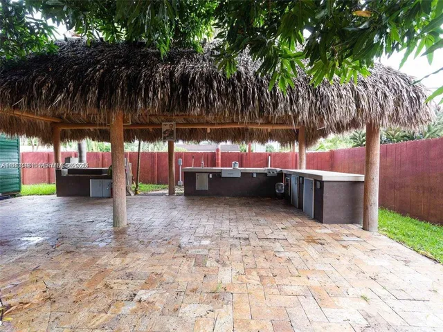 a backyard of a house with a tree