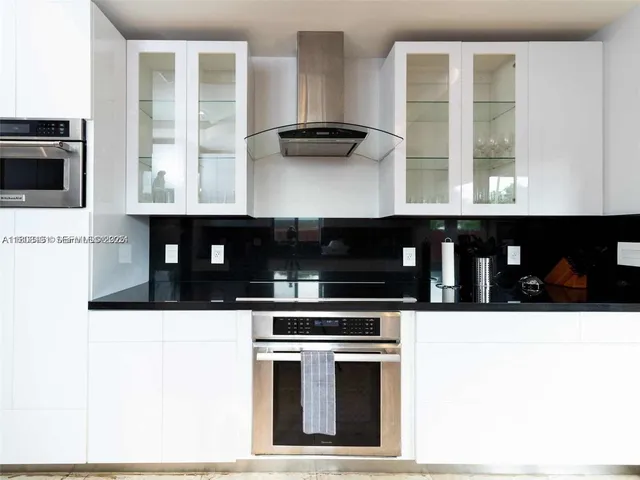 a kitchen with granite countertop a stove and a microwave