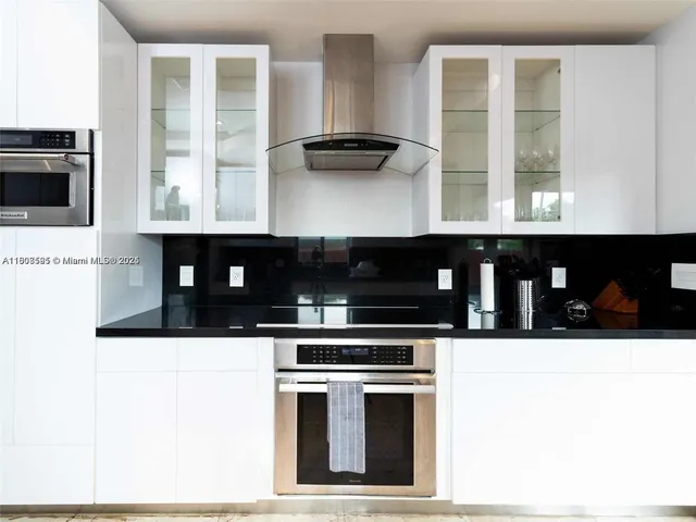 a kitchen with granite countertop a stove and a microwave