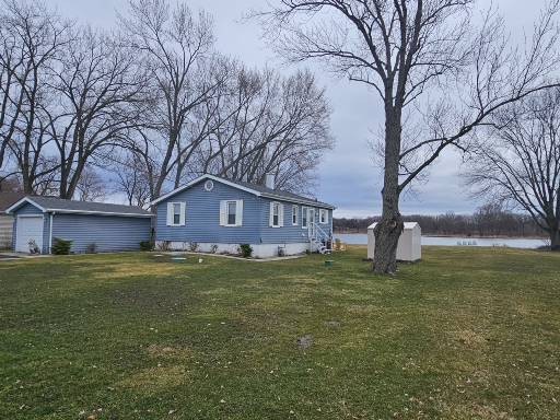 28227 West Fox River Road Cary, IL 60013 - Photo 2 of 13 a house that is sitting in the grass with large trees