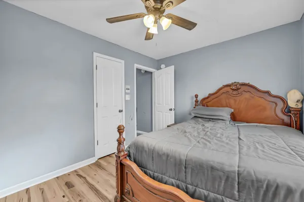 a bedroom with a bed and a chandelier