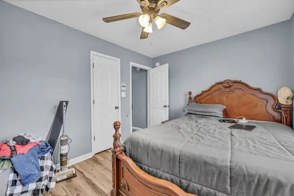 a bedroom with a bed and a chandelier