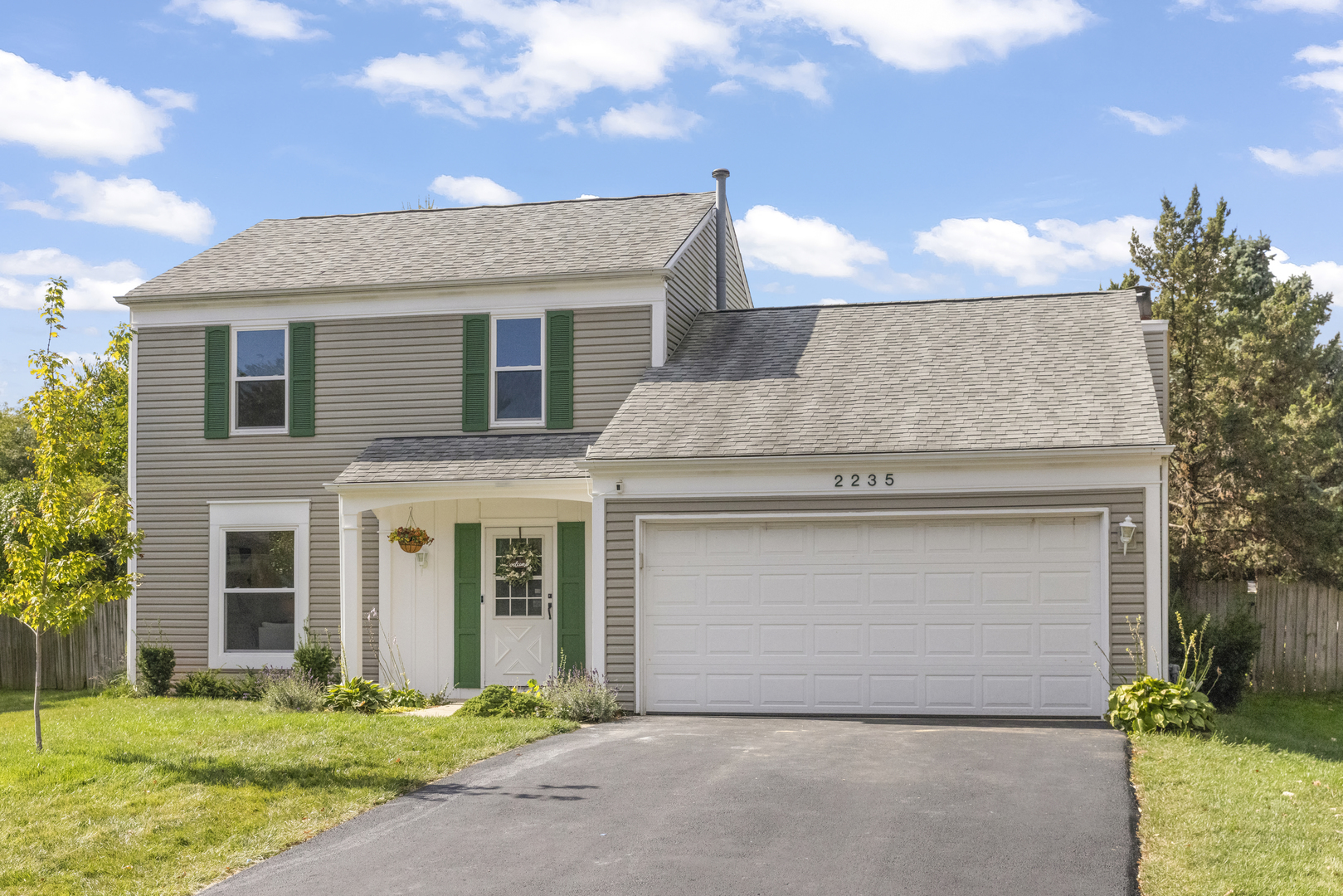 2235 Highfield Court Aurora, IL 60504 - Photo 1 of 31 a front view of a house with a yard and garage