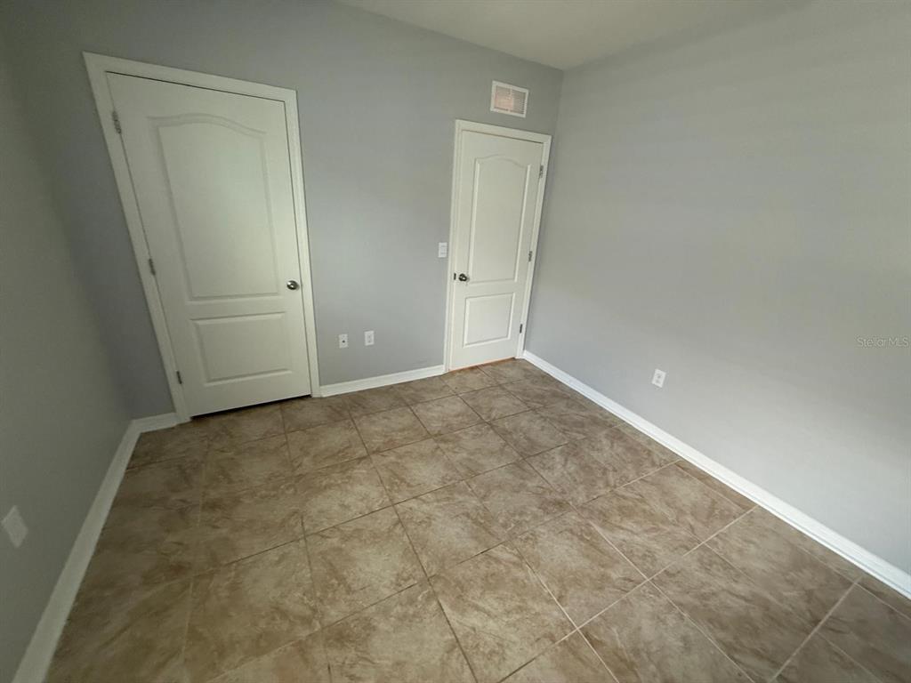 754 Chinoy Road Davenport, FL 33837 - Photo 12 of 26 an empty room with an entryway