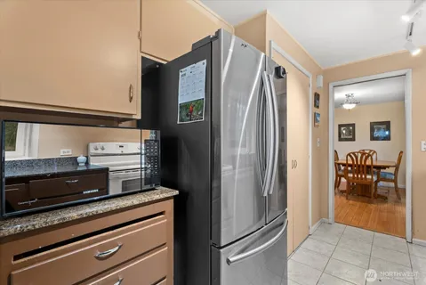 a kitchen with stainless steel appliances a refrigerator and a stove top oven