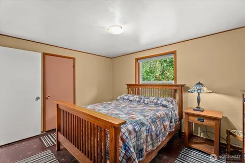 a bedroom with a bed and a window
