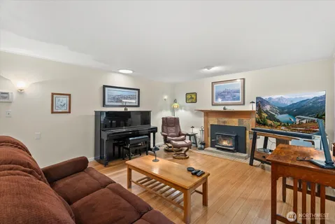 a living room with furniture a flat screen tv and a fireplace