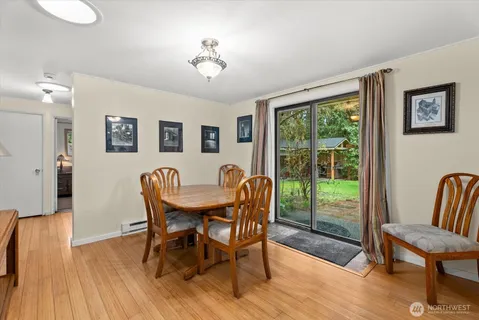 a view of a dining room with furniture window and wooden floor