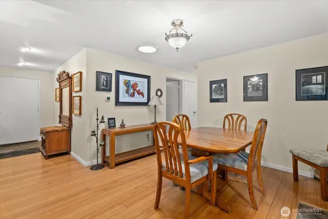 a view of a dining room with furniture and wooden floor