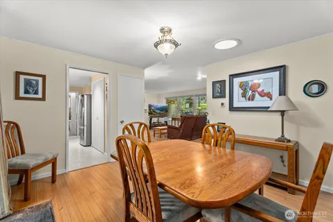 a view of a a dining room with furniture window and wooden floor